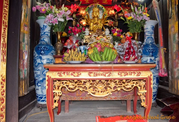 Tet 1 Altar in Temple in Hanoi piled with offerings during Tet celebration