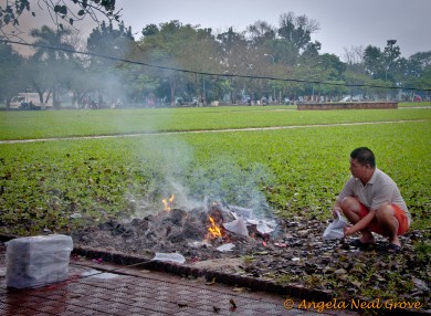 Tet 5 Burning votive money to honor ancestors at Tet. angela neal grove