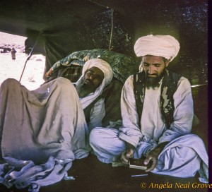 Nomad man in Afghanistan Two men rest against a pile of rugs in their tent in Afghanistan