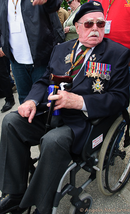 Photo of Veteran with his medals in a wheelchair attending the 70th Anniversary of D-Day | Photo: Angela Neal Grove