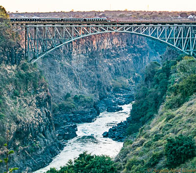 Victoria Falls Smoke That Thunders; Victoria Falls Bridge spans the Zambezi River which is the border between Zambia and Zimbabwe. It is a favorite for bungee jumpers