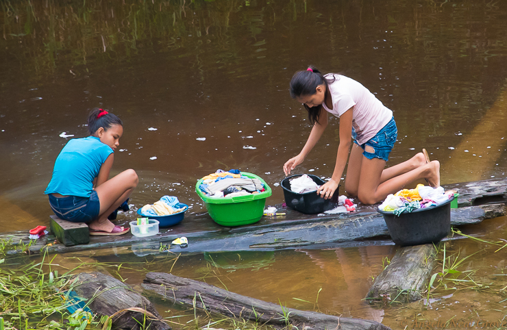 Amazon River Life: Community village life is simple in the Peruvian Amazon. These two young women are washing clothes in a backwater of the river.//PHOTO: ANGROVE