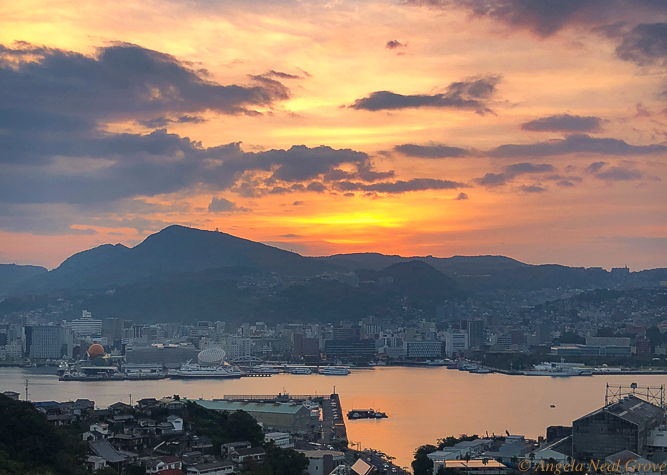 Sunrise over Nagasaki harbor. The force of the Atomic Bomb was contained because Nagasaki is surrounded by hills. This harbor is now rebuilt and is again thriving. With this new day and sunrise is a prayer for peace PHOTO; ANGROVE